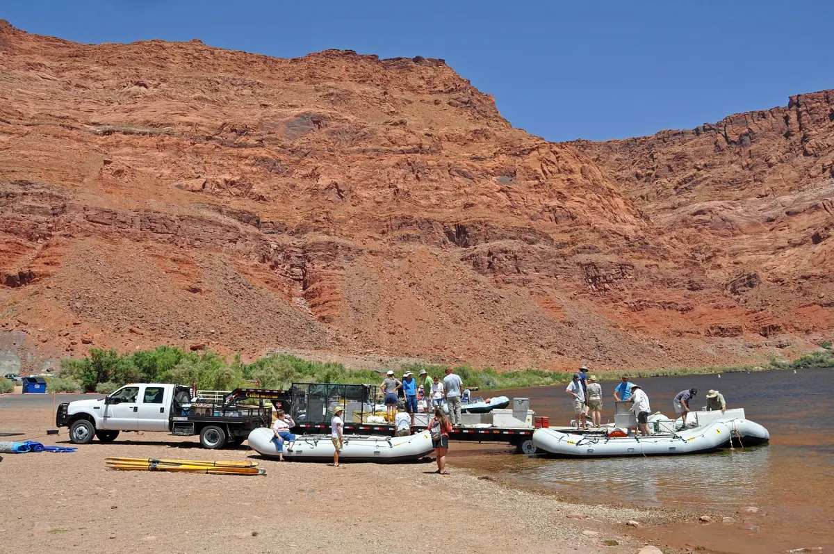 Schlauchboote und ein Lastwagen an der Bootsrampe von Lees Ferry vor roten Felswänden